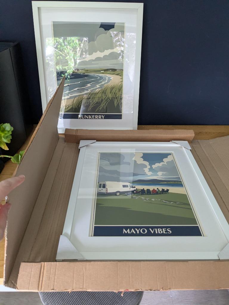 A RetroRoam print of Mayo Vibes in a white frame, arriving securely in its shipping box