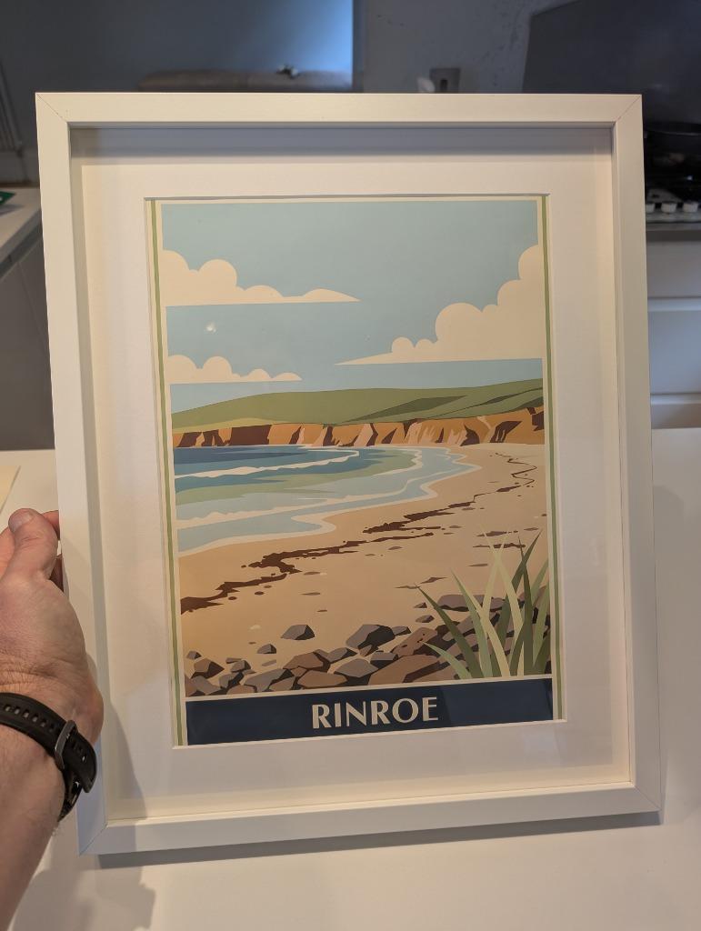 A RetroRoam print of Rinroe in a white frame, held to show size and mount detail