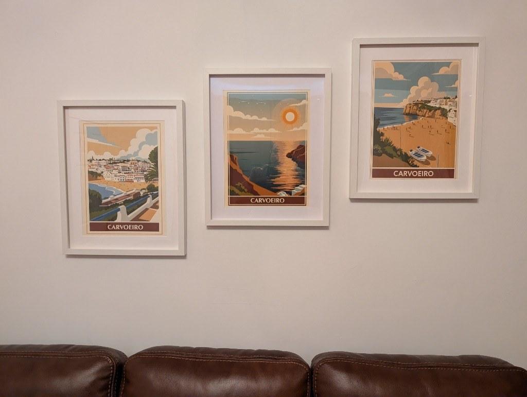 Trio of framed Carvoeiro RetroRoam prints hanging above a sofa