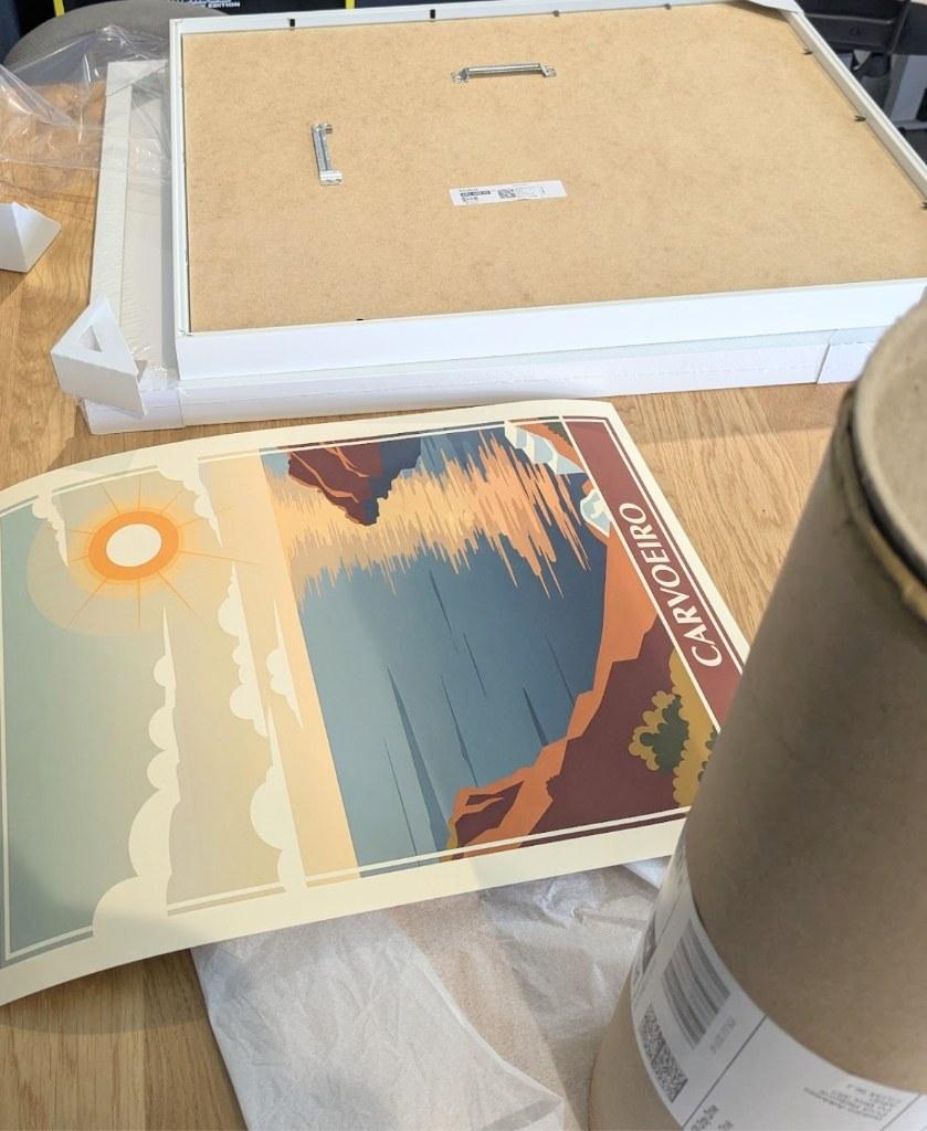 Carvoeiro RetroRoam print being framed next to unboxing tube