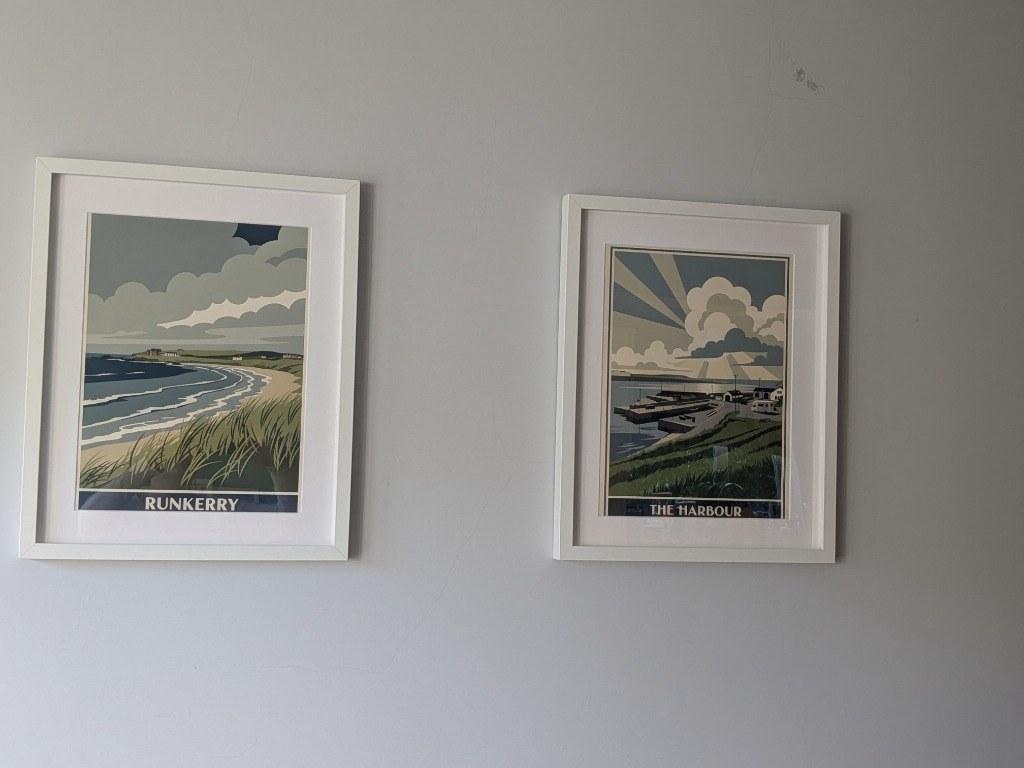 Framed RetroRoam prints of Runkerry and The Harbour side-by-side on wall
